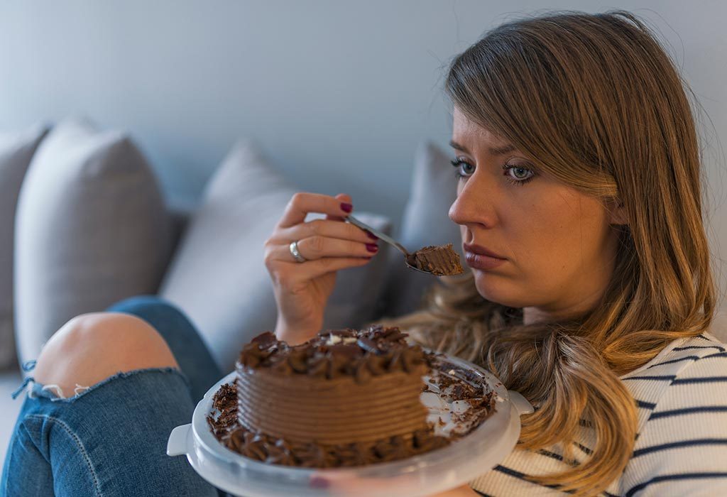 Eine traurige Frau, die Kuchen isst 